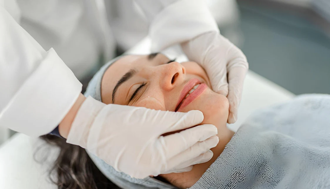 Practitioner assessing a patient's skin during a consultation at an aesthetic clinic in London
