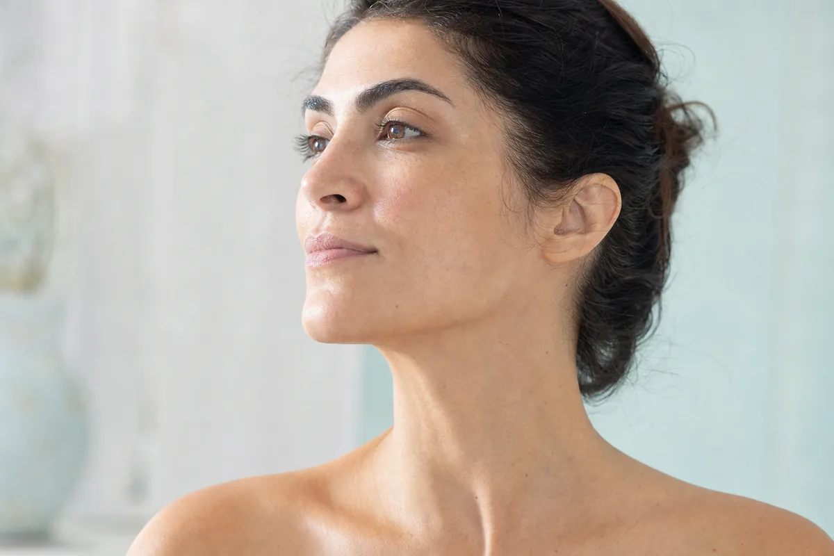 Woman in three quarter profile showing a defined jawline and smooth neck